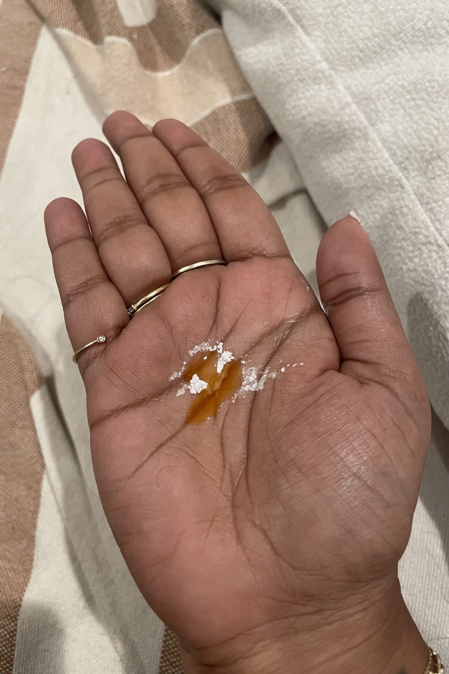 A person holding a piece of true botanicals CBD in their hand.