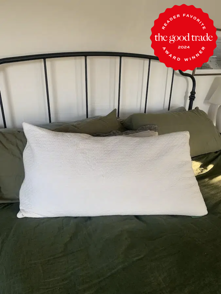 An Avocado pillow on a bed with a TGT reader favorite award badge.