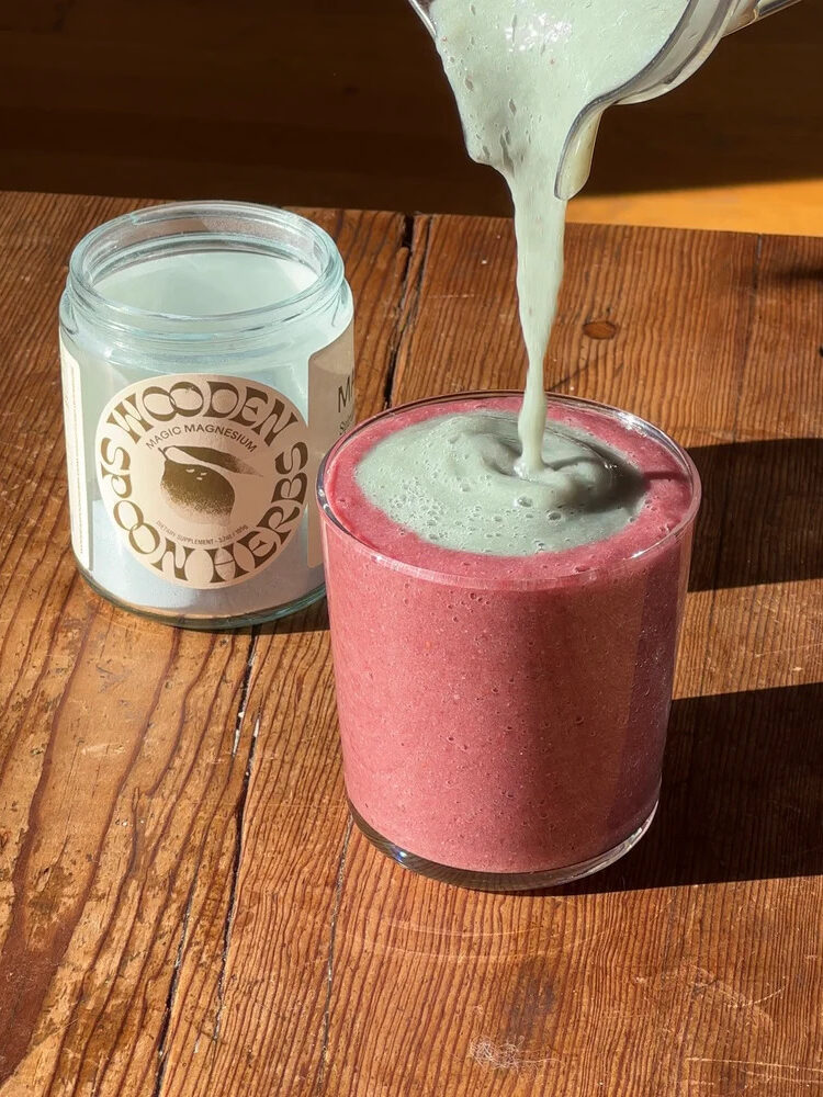 A jar of Wooden Spoon Herbs Magic Magnesium next to a smoothie.