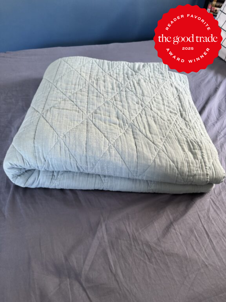 Folded quilt on a bed with an award badge in the corner reading "Reader Favorite, AlsWell Blog, 2025 Award Winner.
