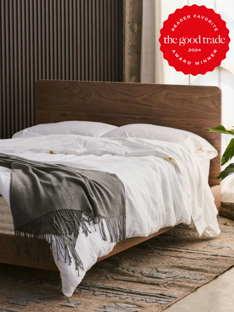A neatly made bed with white sheets and a gray throw blanket. A "AlsWell Blog 2024 Reader Favorite Award Winner" badge is visible in the top right corner.