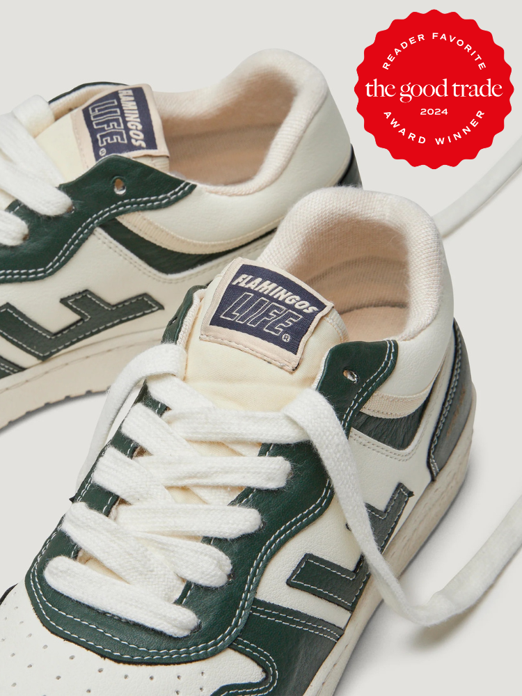 A pair of white and dark green Flamingos Life sustainable sneakers with white laces, alongside a red 2024 "AlsWell Blog" award badge.