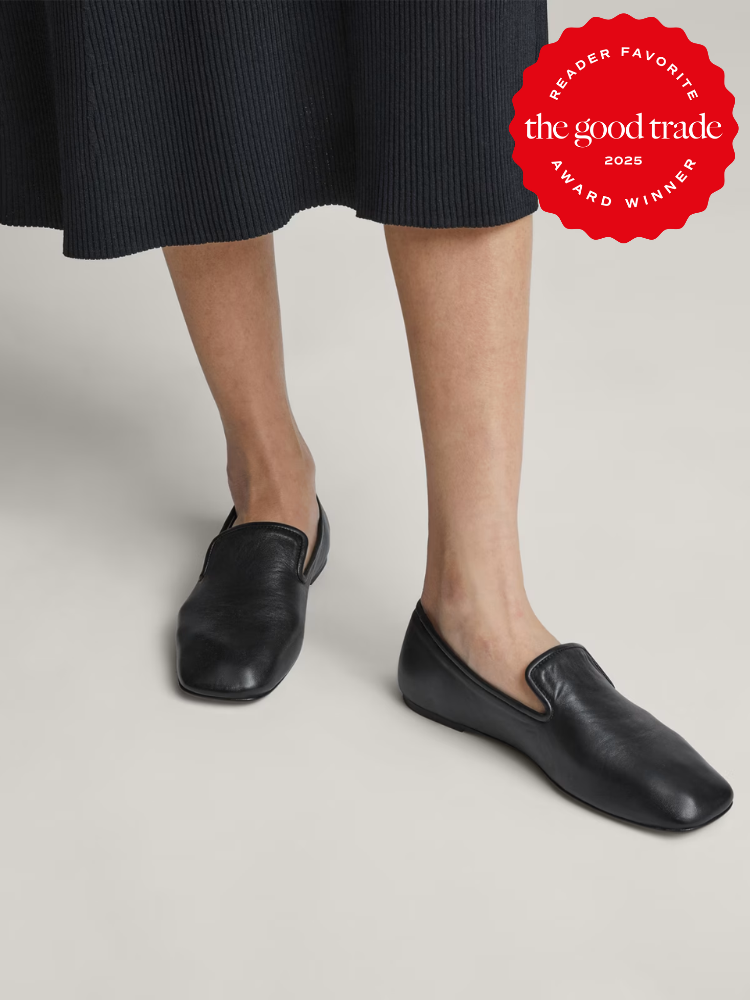 Woman wearing black slip-on loafers and a black skirt. A red award badge for "AlsWell Blog" is in the top right corner.