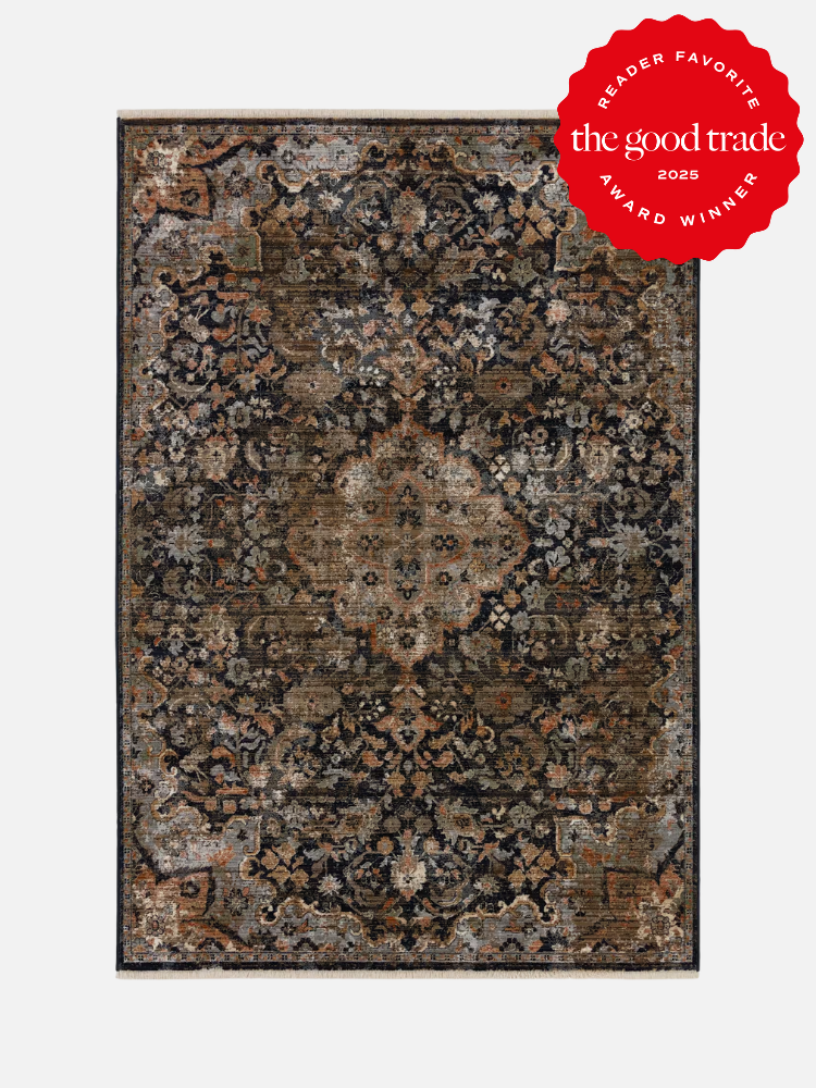 A rectangular, vintage-style rug with a central medallion pattern in dark and muted tones. It features a red "Reader Favorite: AlsWell Blog 2023 Award Winner" badge in the upper right corner.