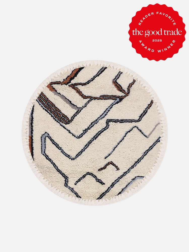 Round beige rug with abstract black and brown lines on a white background. Red badge in the top right corner reads: "Reader Favorite, AlsWell Blog, Award Winner 2025.