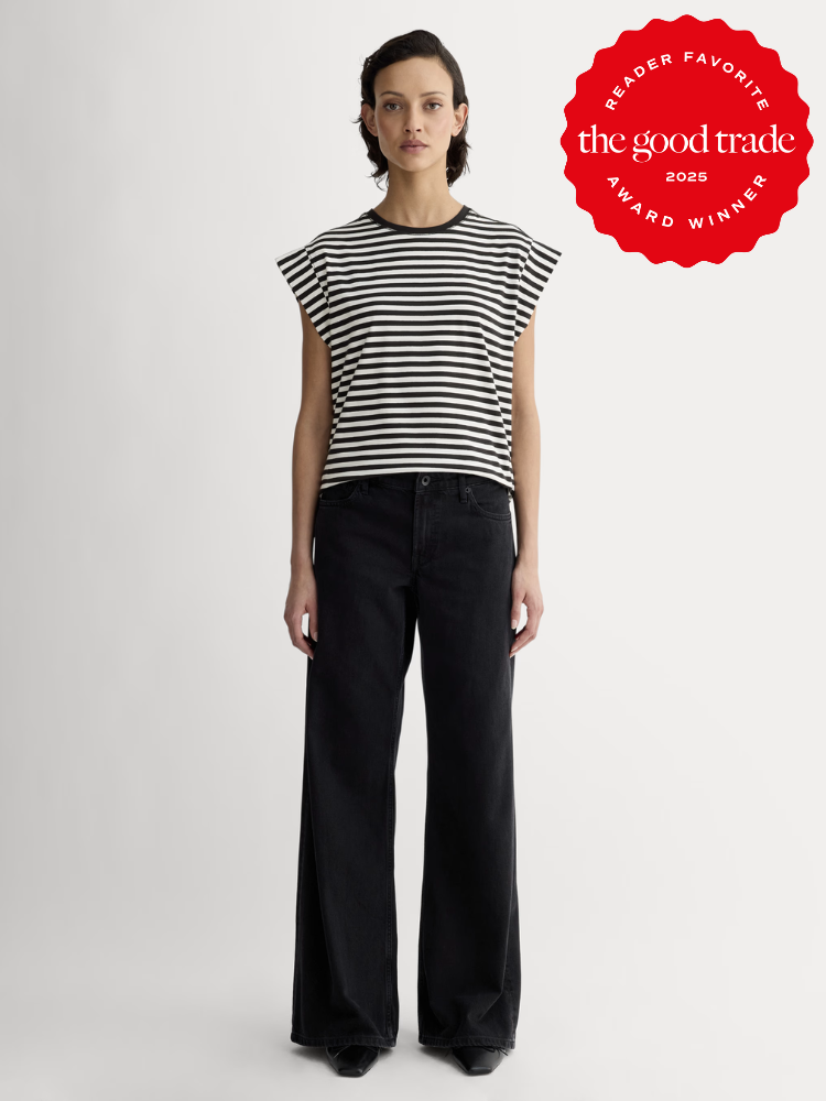 Person wearing a black and white striped shirt and black wide-leg pants stands against a plain background. A red emblem in the corner reads "AlsWell Blog 2023 Reader Favorite Award Winner.