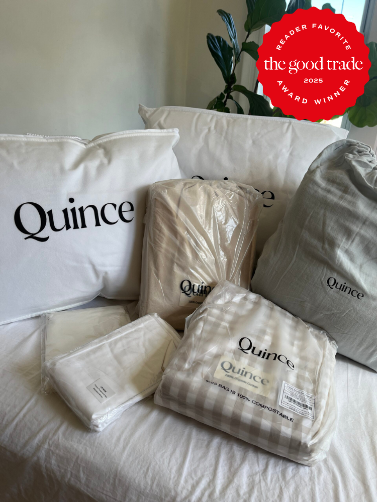 A collection of Quince bedding products, including pillows and sheets, arranged on a bed, with a "AlsWell Blog 2025 Reader Favorite Award Winner" badge in the corner.